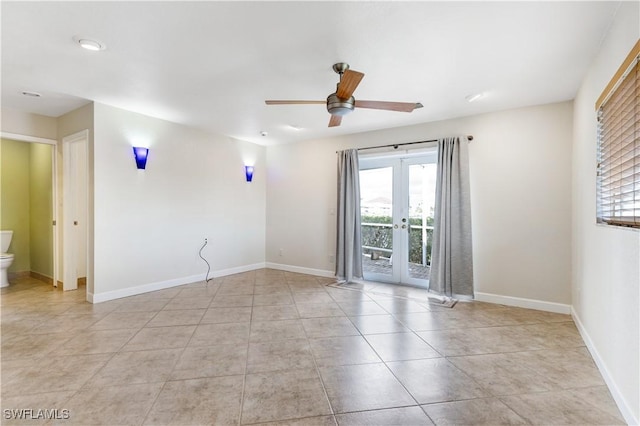 empty room with french doors, a wealth of natural light, and baseboards