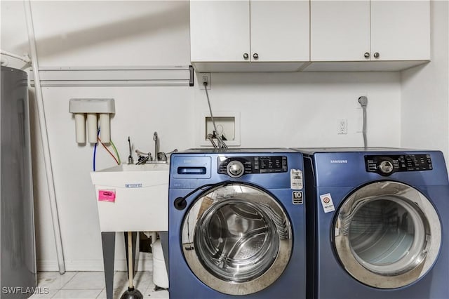 laundry area with cabinet space, independent washer and dryer, and tile patterned floors