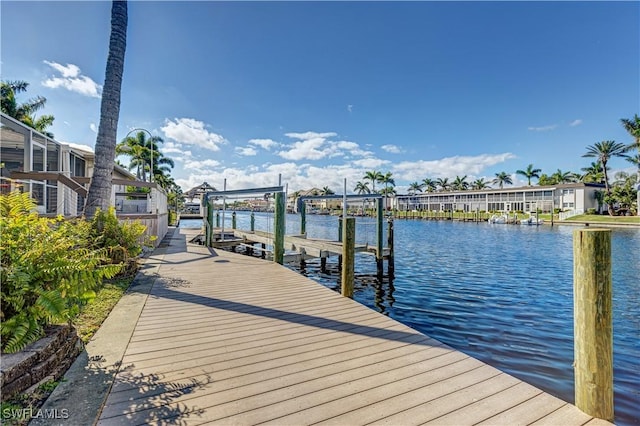 dock area with a water view and boat lift