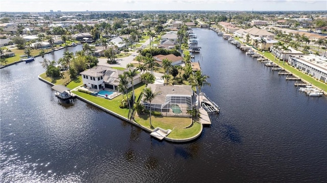 drone / aerial view with a water view and a residential view