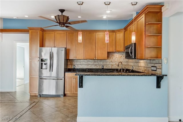 kitchen featuring stainless steel appliances, a peninsula, a sink, open shelves, and dark stone countertops