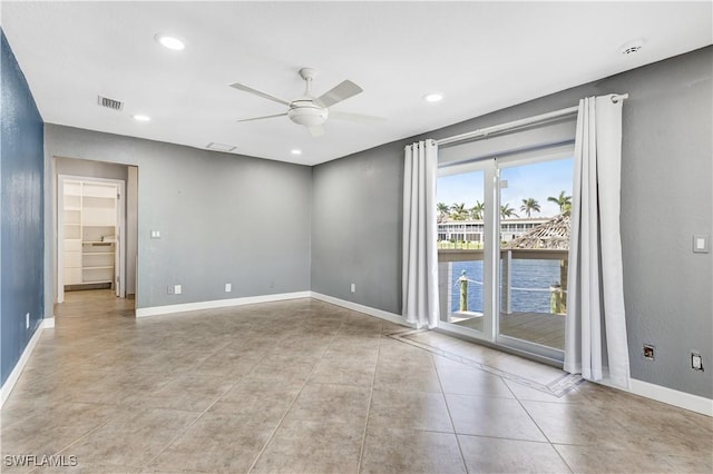 empty room with baseboards, recessed lighting, visible vents, and a ceiling fan