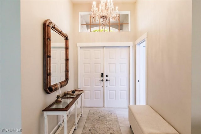 entrance foyer featuring an inviting chandelier and a towering ceiling