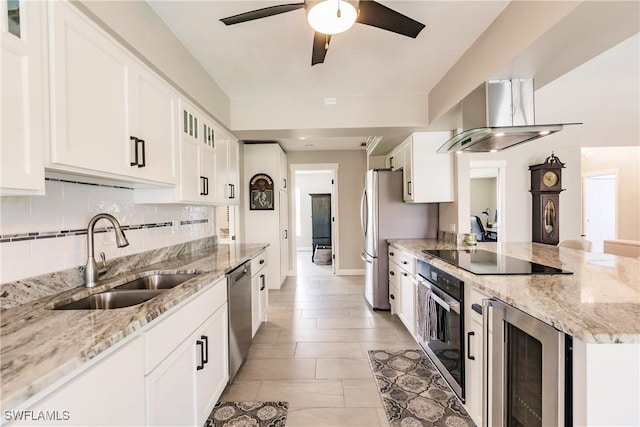 kitchen featuring stainless steel appliances, wine cooler, sink, white cabinets, and island range hood