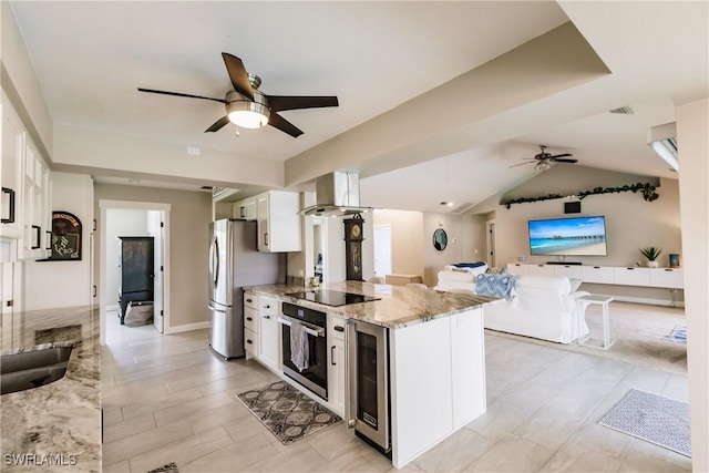 kitchen with stainless steel appliances, wine cooler, light stone countertops, range hood, and white cabinets