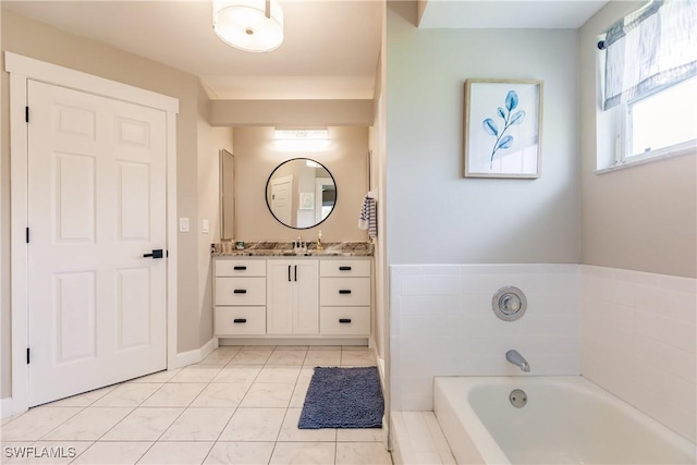 bathroom featuring a washtub, tile patterned flooring, and vanity