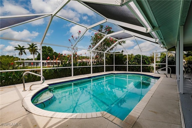 view of swimming pool featuring a patio and a lanai