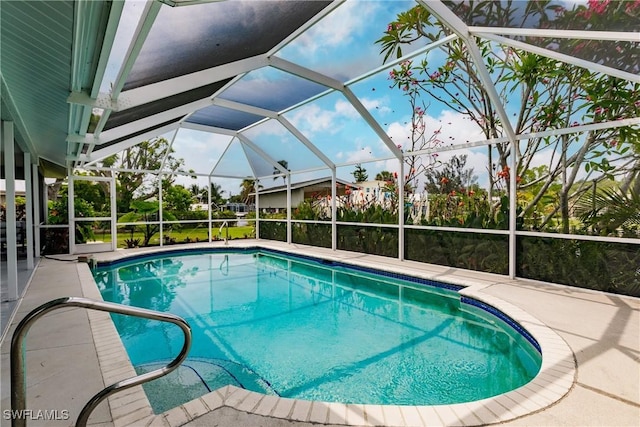 view of swimming pool with a patio area and glass enclosure