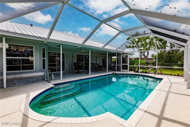 view of pool featuring a patio and glass enclosure