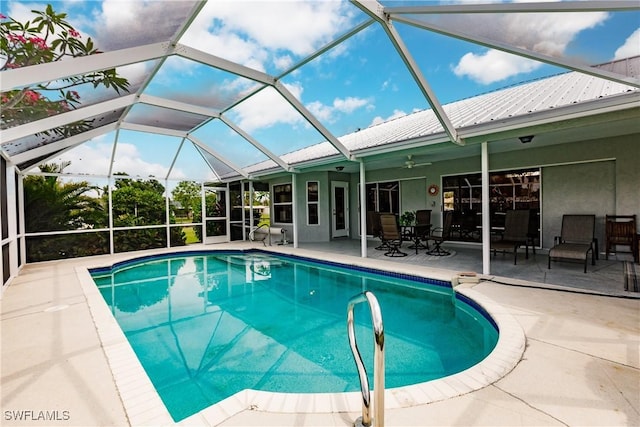 view of pool with a patio area, ceiling fan, and a lanai