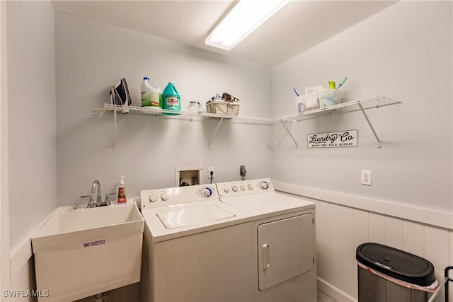 laundry room with washer and dryer and sink