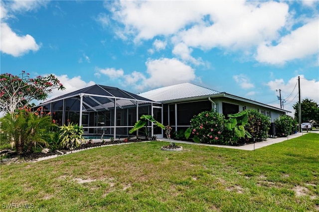 view of front facade with a front lawn and glass enclosure