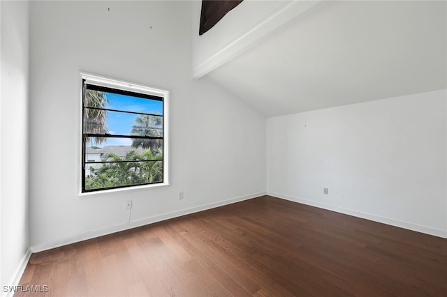 additional living space with dark wood-type flooring, lofted ceiling with beams, and baseboards