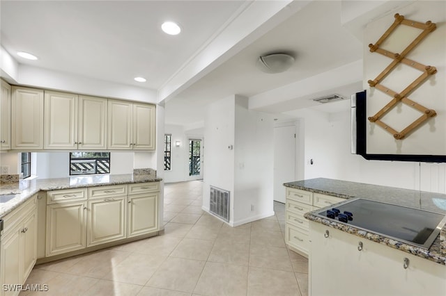 kitchen featuring black electric stovetop, cream cabinets, visible vents, and recessed lighting