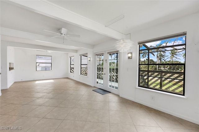 empty room featuring beam ceiling, light tile patterned flooring, and baseboards