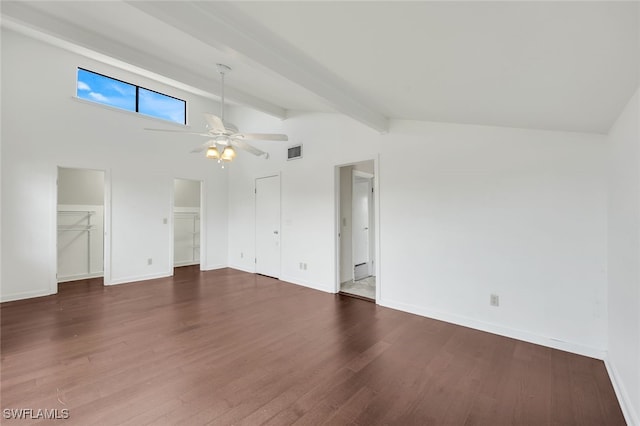 interior space with lofted ceiling with beams, dark wood-style flooring, a ceiling fan, visible vents, and baseboards