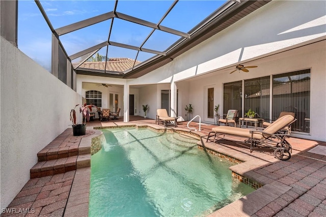 pool with a lanai, a patio, and ceiling fan