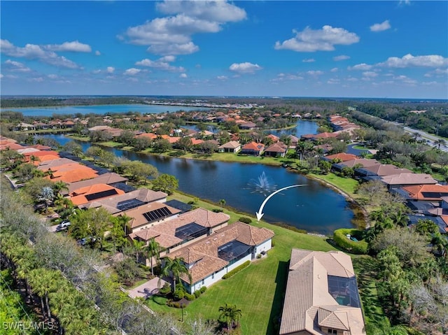 birds eye view of property with a water view and a residential view