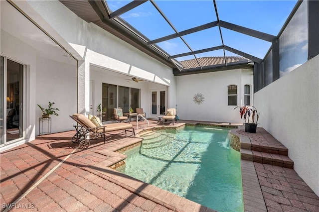 pool featuring glass enclosure, ceiling fan, a patio, and french doors