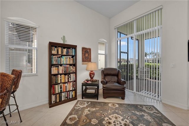 living area featuring tile patterned flooring and baseboards