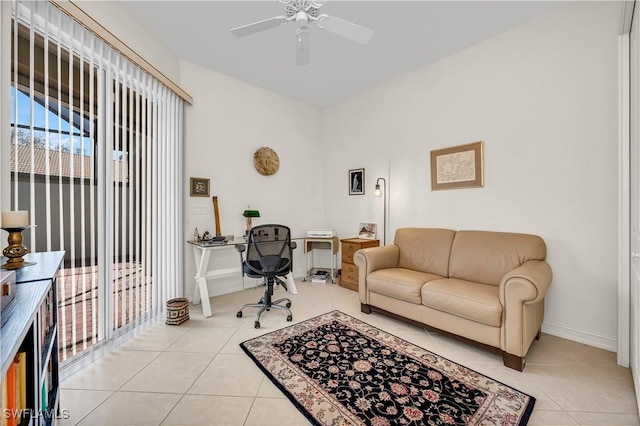 office area featuring ceiling fan, light tile patterned flooring, and baseboards