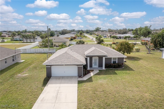 view of front of property featuring a front yard and a garage