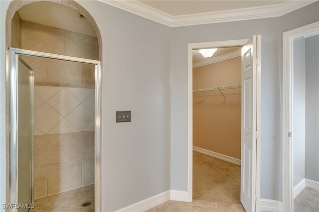 bathroom featuring tile patterned flooring, walk in shower, and crown molding