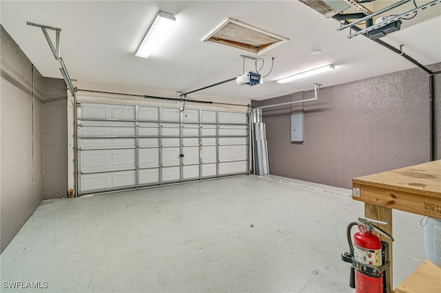 garage with electric panel and a garage door opener