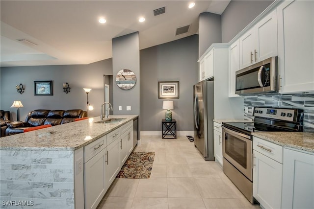 kitchen with visible vents, appliances with stainless steel finishes, open floor plan, and a sink