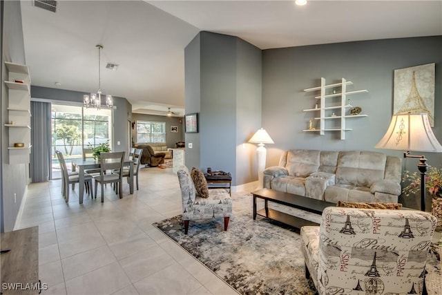 living room featuring light tile patterned floors, vaulted ceiling, visible vents, and a chandelier