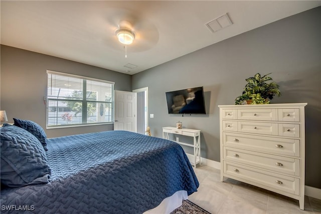 bedroom with visible vents, ceiling fan, baseboards, and light tile patterned floors