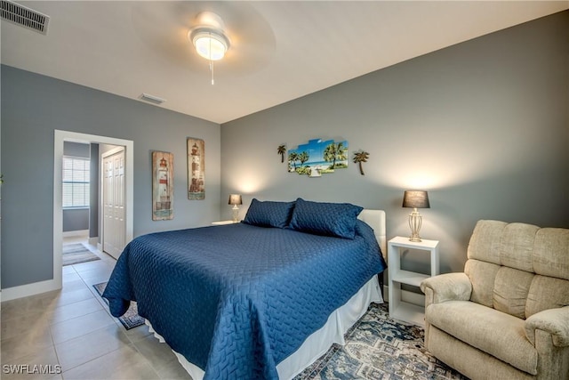 bedroom with a ceiling fan, tile patterned flooring, visible vents, and baseboards