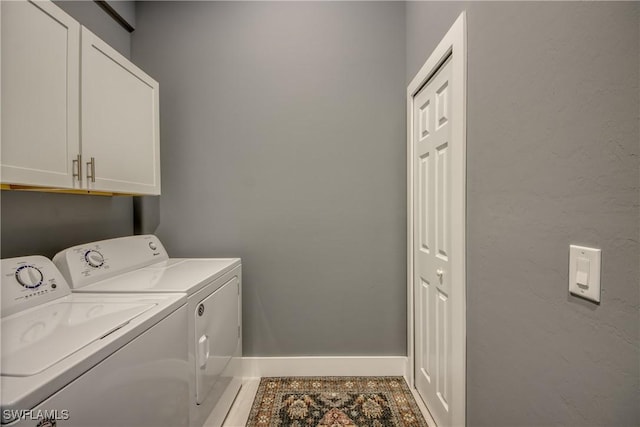 laundry area with cabinet space, baseboards, and washing machine and clothes dryer