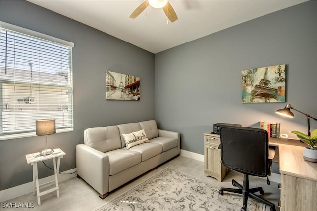 home office featuring a ceiling fan and baseboards