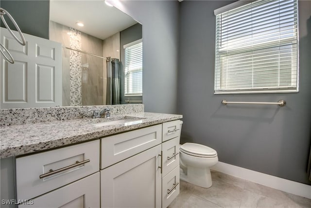 bathroom with curtained shower, tile patterned flooring, toilet, vanity, and baseboards