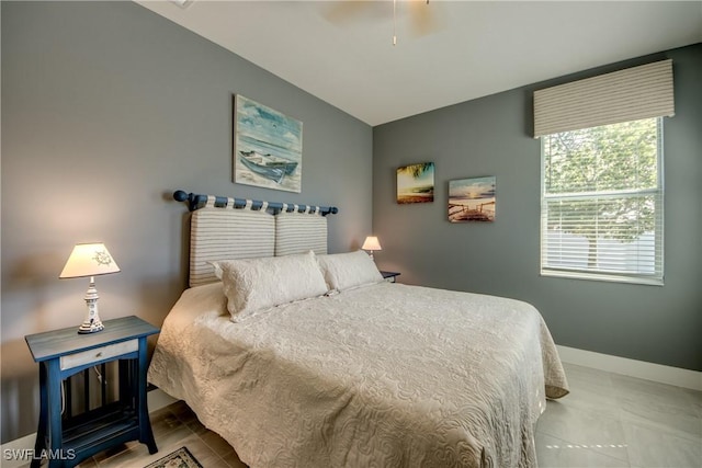 bedroom with lofted ceiling, a ceiling fan, and baseboards