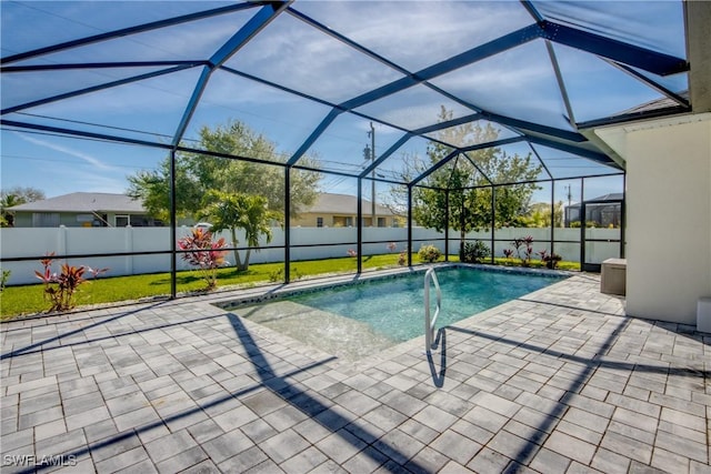 view of pool featuring a patio, a fenced backyard, glass enclosure, and a fenced in pool