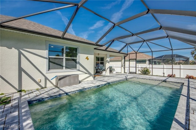 view of swimming pool featuring a patio, a lanai, a fenced in pool, and fence