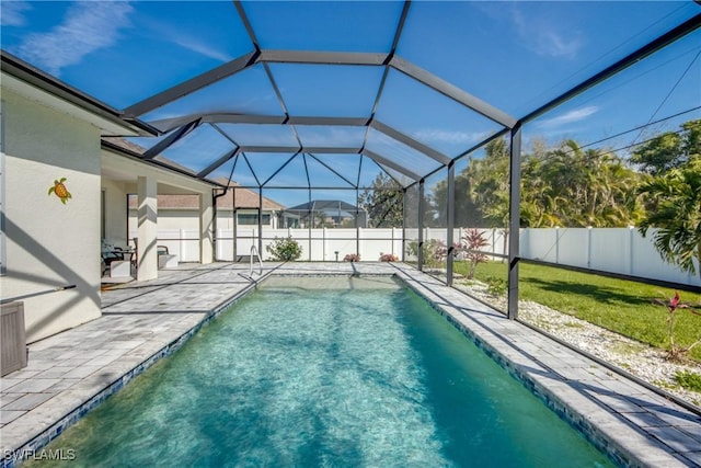 view of pool with a fenced in pool, glass enclosure, a fenced backyard, and a patio