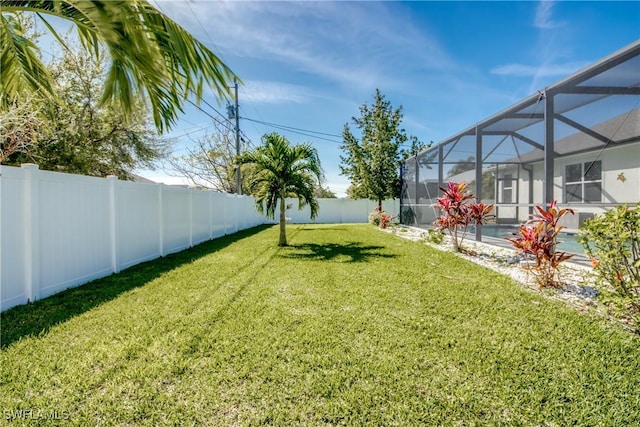 view of yard with a fenced in pool, a lanai, and a fenced backyard