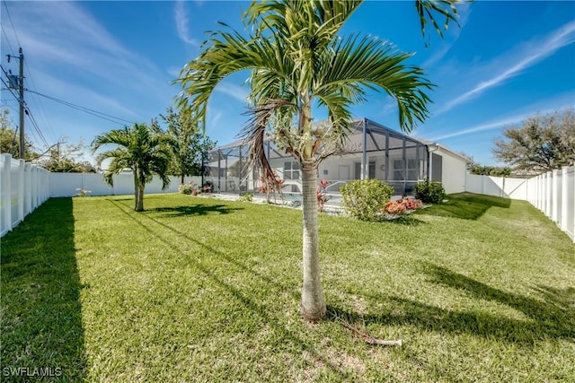 view of yard featuring a lanai and a fenced backyard