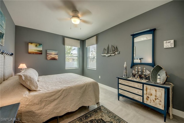 bedroom featuring ceiling fan, baseboards, and tile patterned floors