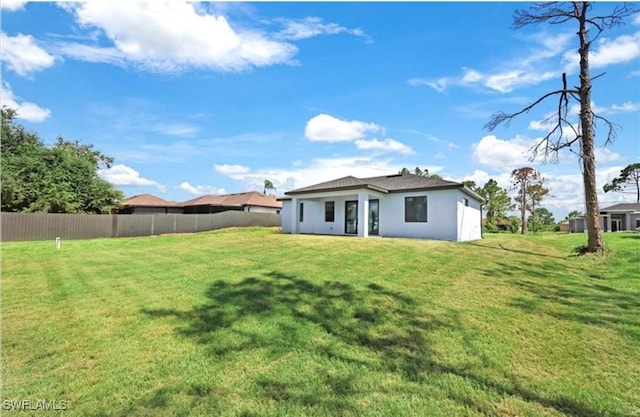 back of house with a lawn