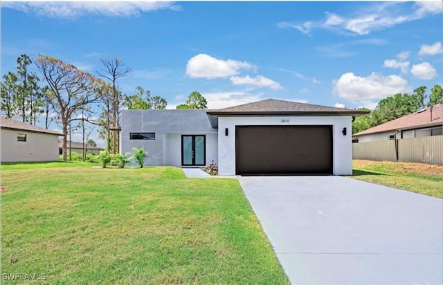 view of front of property with a front lawn and a garage