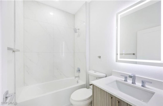 full bathroom with tiled shower / bath combo, vanity, and toilet