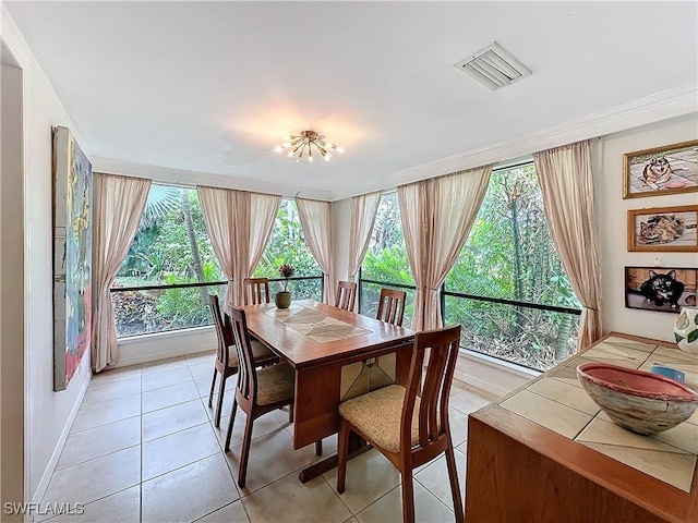 dining room featuring plenty of natural light, visible vents, baseboards, and light tile patterned flooring