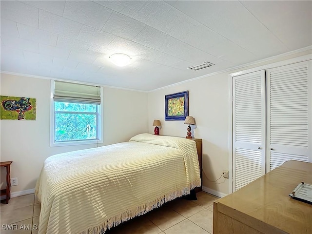 bedroom featuring light tile patterned floors, baseboards, visible vents, and crown molding