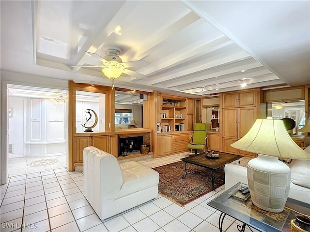 living room with beamed ceiling, light tile patterned flooring, a ceiling fan, and built in features