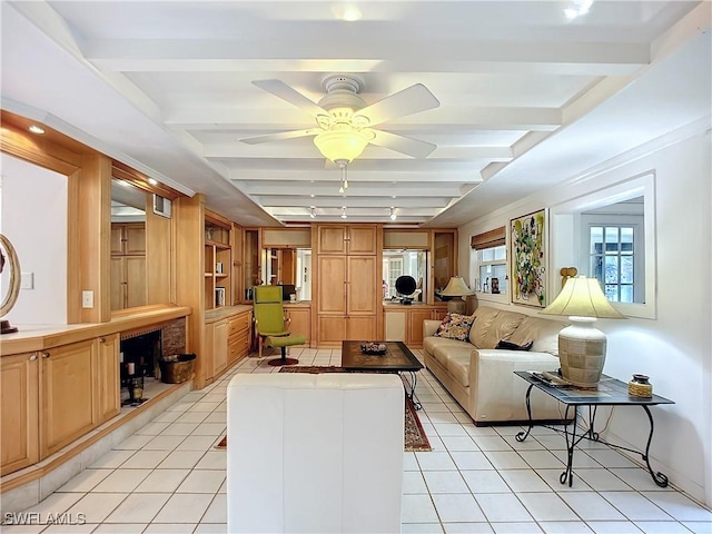 living area featuring ceiling fan, beamed ceiling, light tile patterned flooring, and built in features