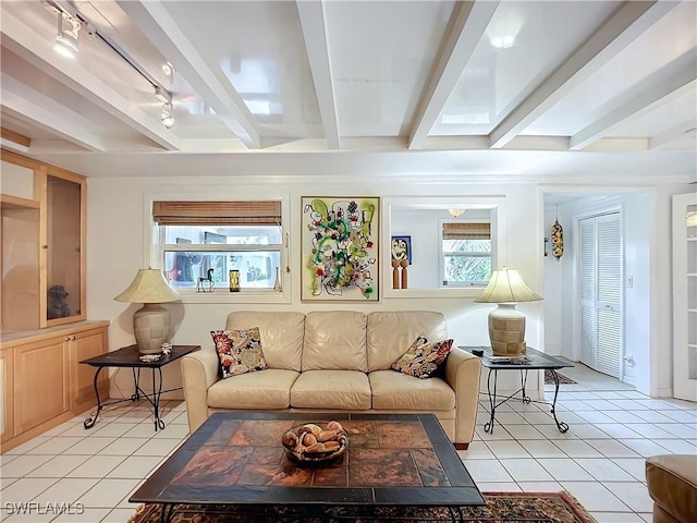 living room featuring light tile patterned floors, beam ceiling, and track lighting